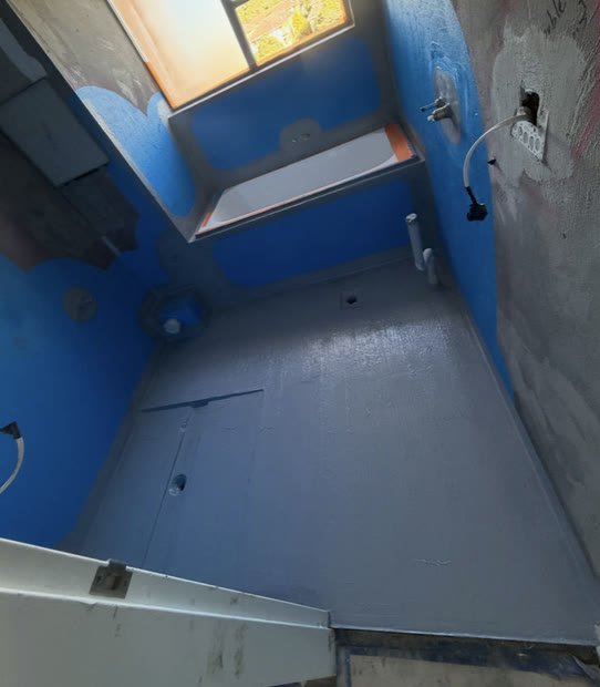 Bathroom floor and walls coated in blue membrane