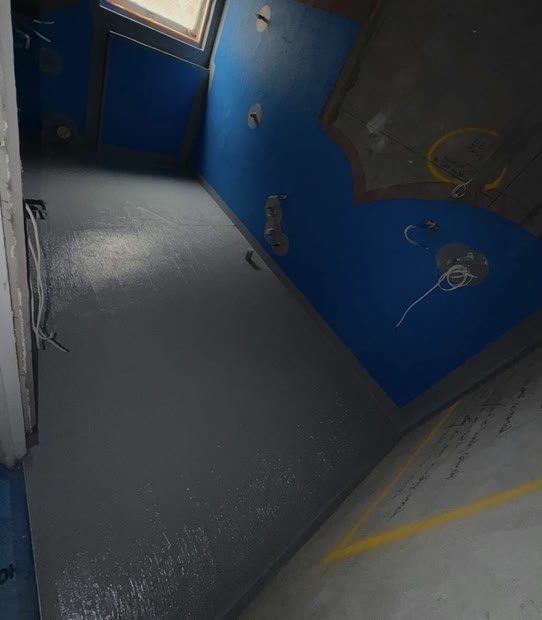 Wet area doorway with sealed floor coating