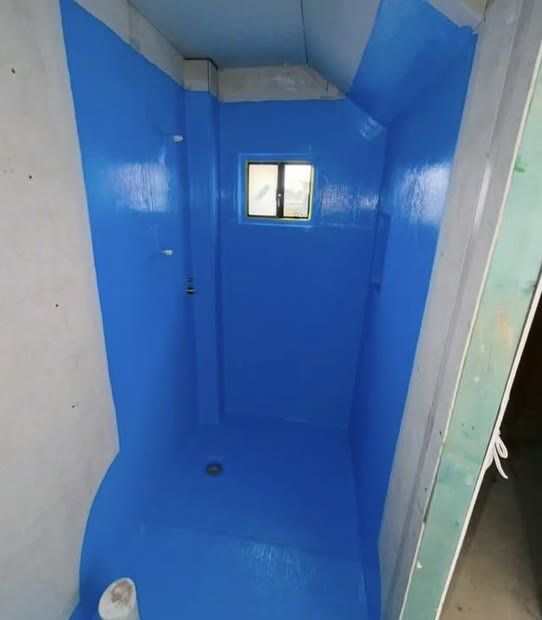 Shower recess fully coated in blue waterproof membrane